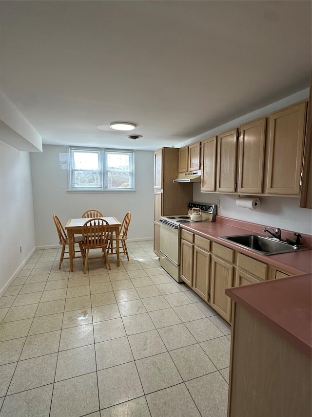 kitchen featuring range with electric cooktop, a sink, under cabinet range hood, light tile patterned flooring, and baseboards