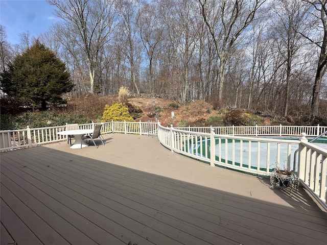 wooden terrace with a fenced in pool