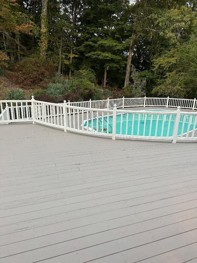 view of pool with a fenced in pool, a deck, and fence