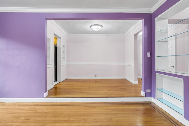 hallway with crown molding and light hardwood / wood-style flooring