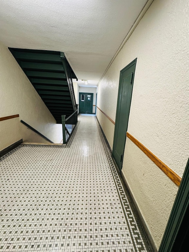 hallway with a textured ceiling