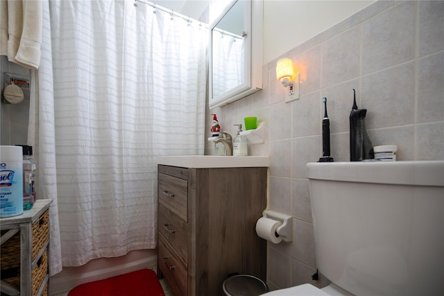 bathroom with shower / bath combo, vanity, and tile walls