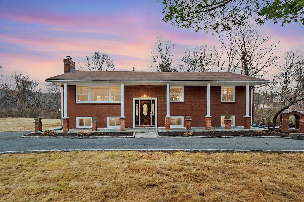 bi-level home featuring a yard