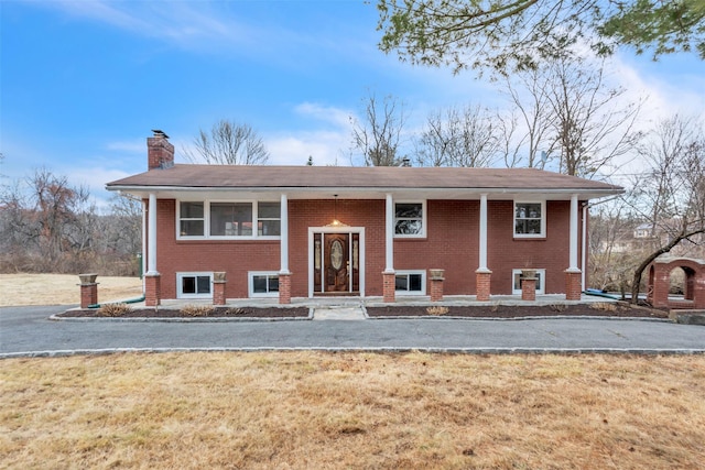 bi-level home with a front lawn