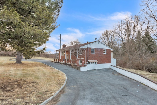 view of side of home featuring covered porch