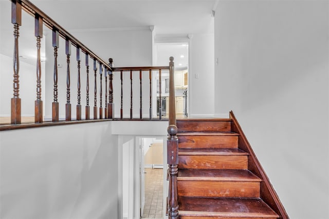 stairway featuring crown molding