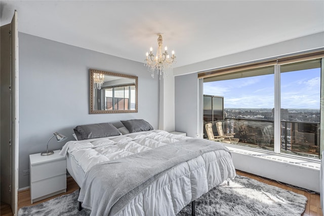 bedroom featuring hardwood / wood-style flooring and a notable chandelier