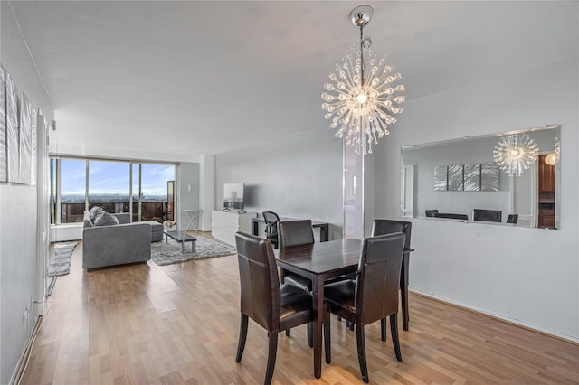 dining area featuring an inviting chandelier and light hardwood / wood-style floors