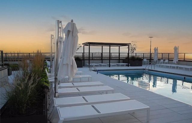 pool at dusk with a patio