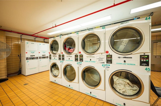 washroom with stacked washing maching and dryer and washer and clothes dryer