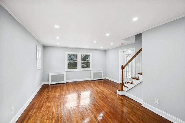 interior space featuring hardwood / wood-style floors, radiator, and crown molding