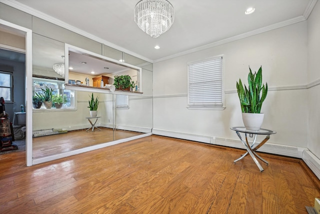 interior space featuring a chandelier, crown molding, and wood-type flooring