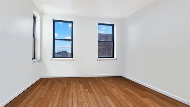 empty room featuring light hardwood / wood-style floors and ornamental molding