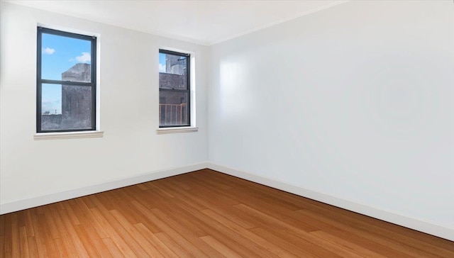 unfurnished room with hardwood / wood-style flooring