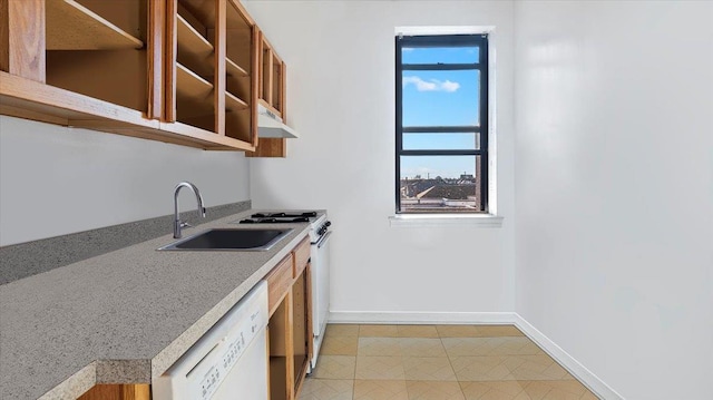 kitchen with sink, white dishwasher, and light tile patterned floors