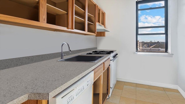 kitchen with light tile patterned floors, white appliances, and sink