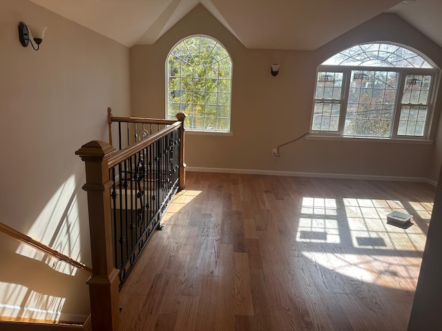 interior space featuring hardwood / wood-style floors and vaulted ceiling