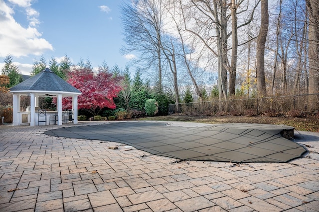 view of swimming pool featuring a gazebo, exterior bar, and a patio