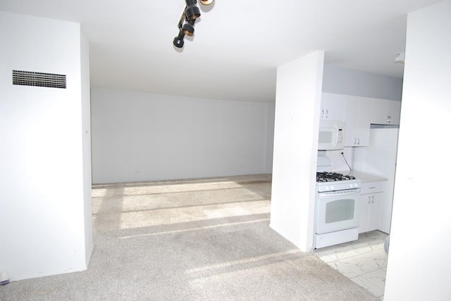 kitchen featuring white cabinets, white appliances, and light colored carpet