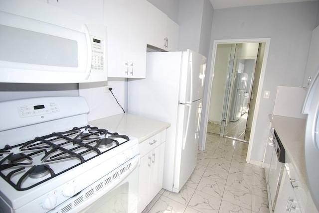 kitchen with white appliances and white cabinetry