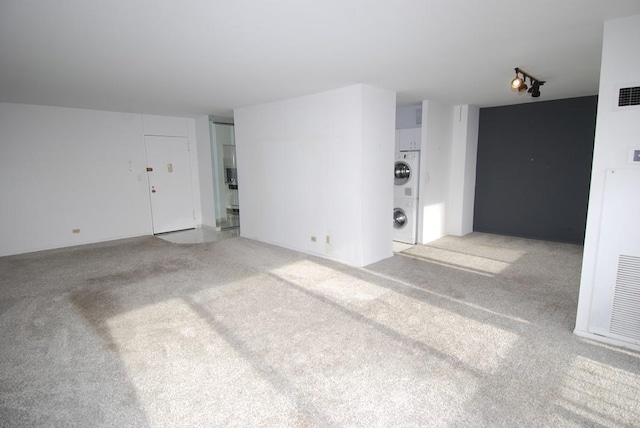 unfurnished living room with light colored carpet