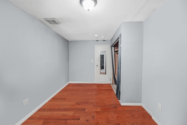 hall with wood-type flooring