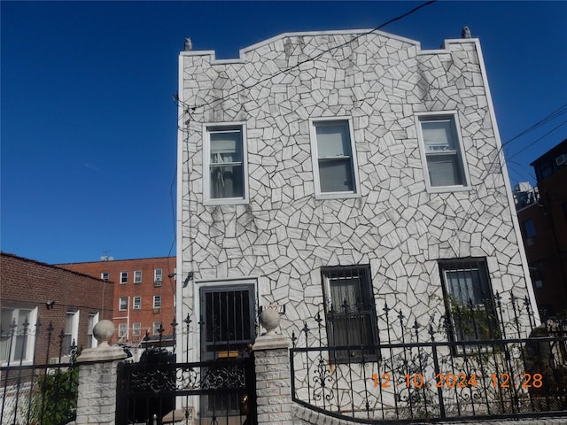 1027 E 83rd St E Unit 2, Brooklyn, NY 11236 - view of front of home with a fenced front yard and stone siding