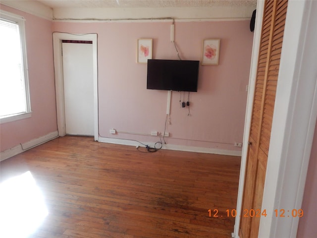 1027 E 83rd St E Unit 2, Brooklyn, NY 11236 - unfurnished living room featuring wood finished floors and baseboards