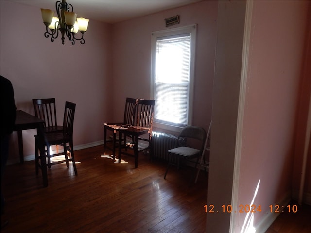 sitting room featuring dark hardwood / wood-style floors and a chandelier