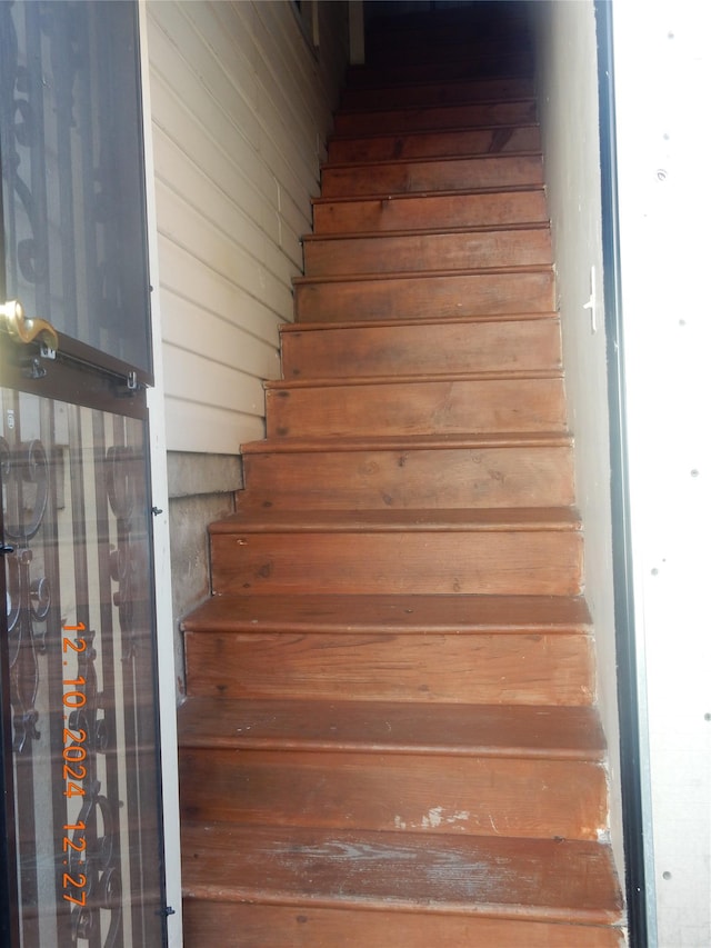 stairs with wood walls