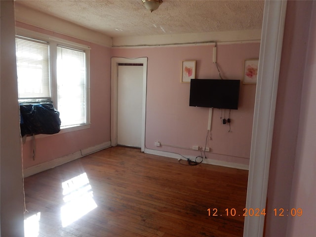 interior space with hardwood / wood-style flooring and a textured ceiling