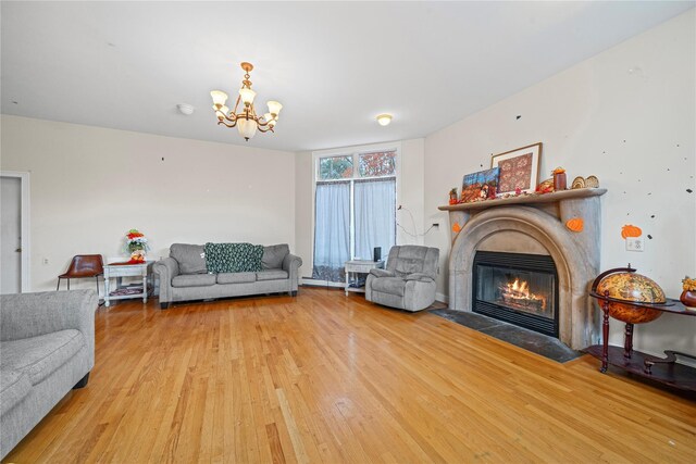 living room with light wood-type flooring and a notable chandelier