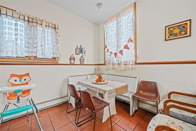 dining space featuring light tile patterned floors and a baseboard heating unit