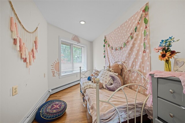 bedroom featuring light hardwood / wood-style floors and a baseboard radiator