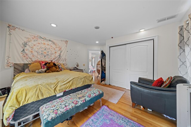 bedroom featuring hardwood / wood-style flooring and a closet