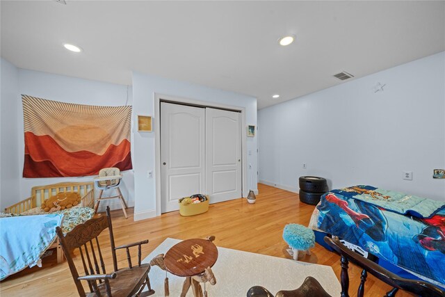 bedroom featuring hardwood / wood-style floors and a closet