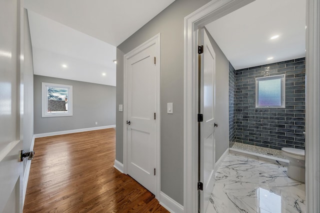 bathroom with hardwood / wood-style flooring and toilet