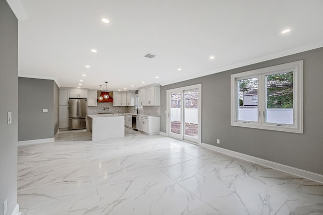 unfurnished living room with crown molding and sink