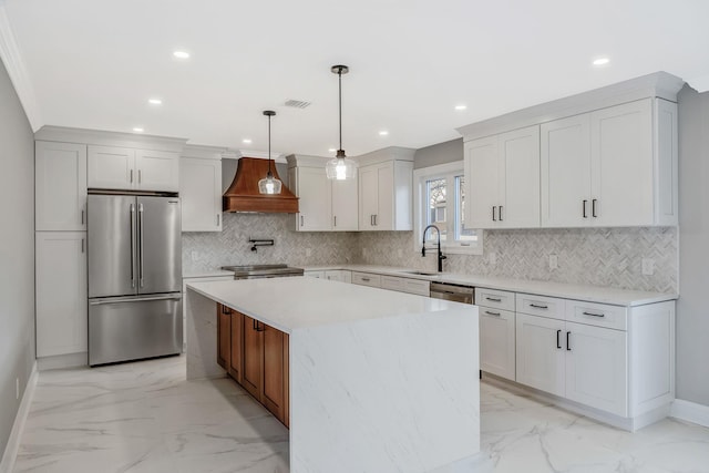 kitchen featuring custom exhaust hood, a center island, white cabinets, decorative light fixtures, and stainless steel appliances