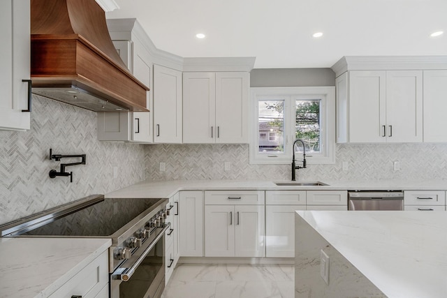 kitchen featuring white cabinets, sink, custom range hood, and stainless steel appliances