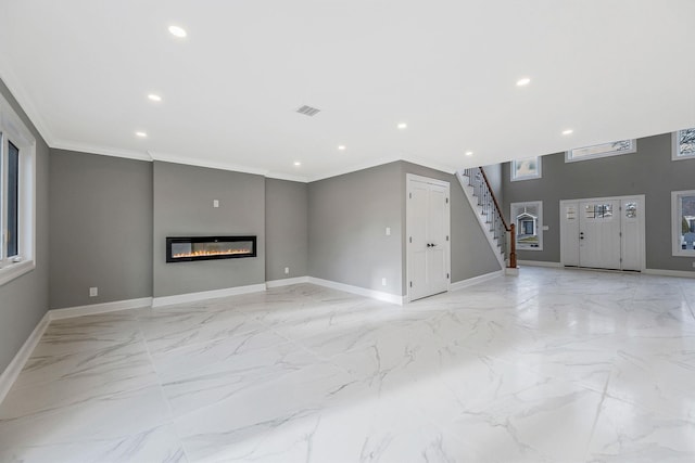 unfurnished living room featuring ornamental molding