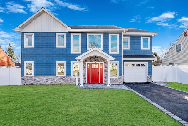 view of front of home with a garage and a front lawn