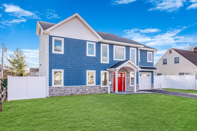 view of front of home with a front yard and a garage