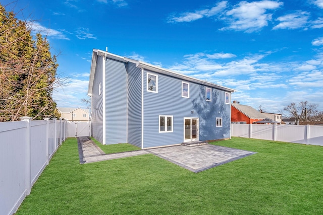 rear view of house with a lawn and a patio area