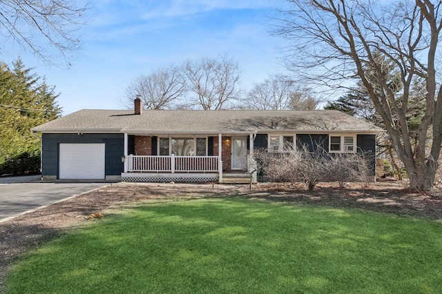 ranch-style house featuring an attached garage, covered porch, a chimney, a front lawn, and concrete driveway