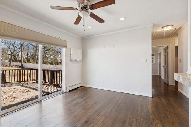 unfurnished room featuring a baseboard heating unit, baseboards, attic access, and wood finished floors