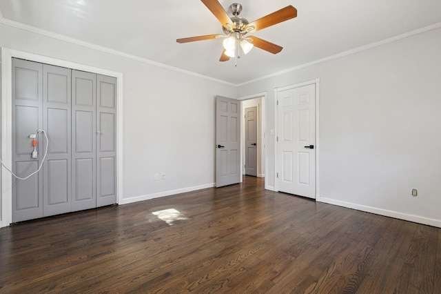 unfurnished bedroom with baseboards, dark wood-type flooring, ornamental molding, and a ceiling fan