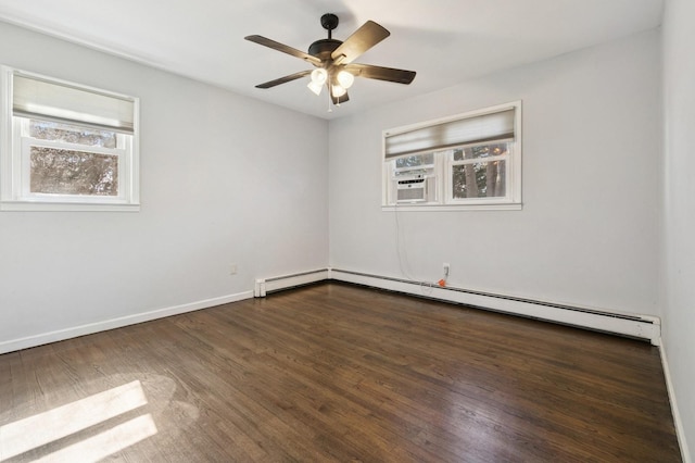 spare room with a baseboard heating unit, dark wood-style floors, cooling unit, baseboards, and ceiling fan