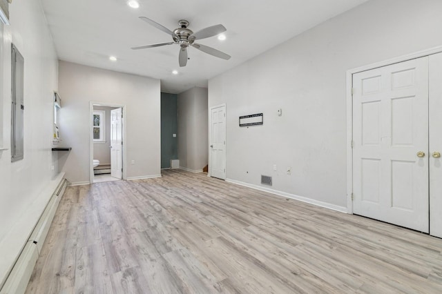 unfurnished bedroom featuring light wood-style flooring, ensuite bath, recessed lighting, a baseboard radiator, and baseboards