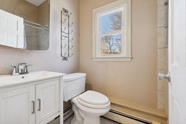 bathroom with vanity, toilet, and baseboard heating